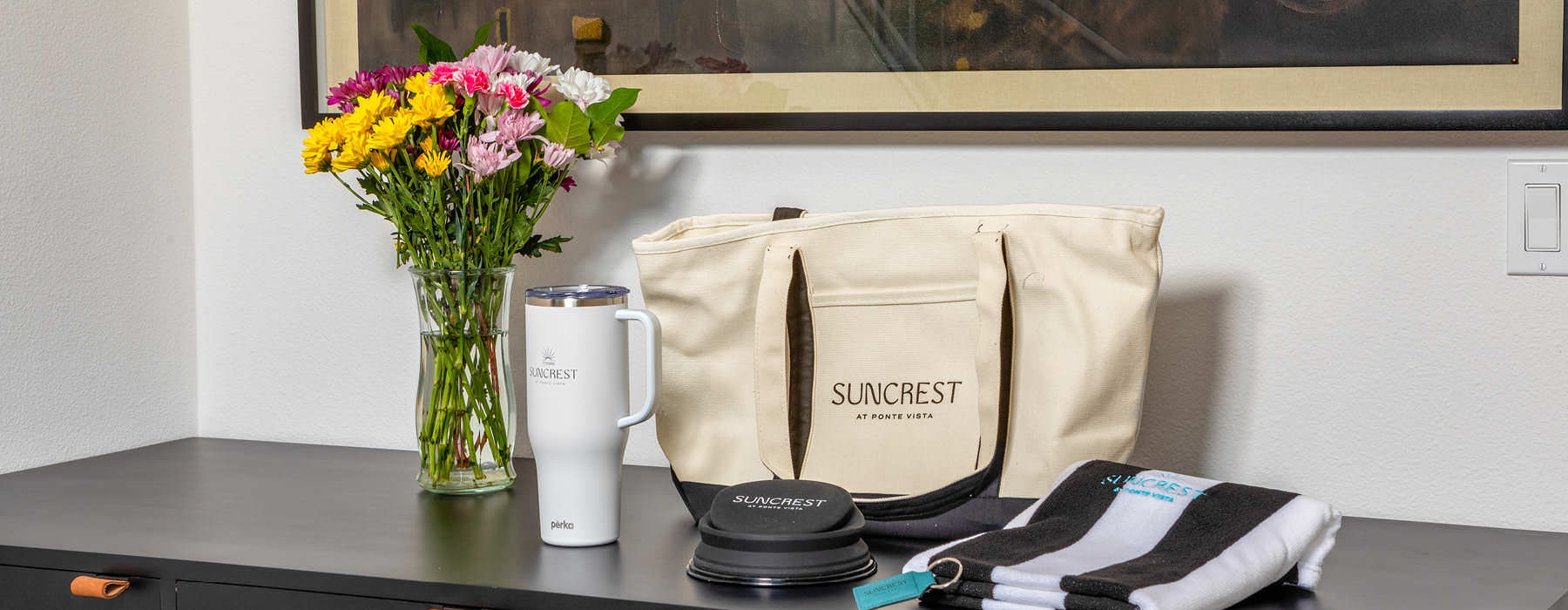 Detail of a hallway at Suncrest at Ponte Vista townhomes for rent in San Pedro, CA, featuring desk with Suncrest merch.