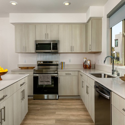 well lit kitchen with windows and island